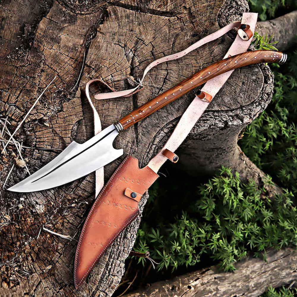 Hand-forged J2 high carbon steel Viking spear with polished wooden handle and leather sheath resting on a wooden tree stump. Norse medieval collector's weapon replica for LARP, cosplay, and unique decor.