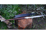Handmade Viking Spear with 39-inch Carbon Steel Blade and long wooden handle, displayed next to its black handmade leather sheath on a wooden log.